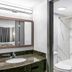 Red Roof Inn Richmond - Airport Sandston bathroom with sink, mirror, and shower-tub combo
