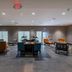Four Points by Sheraton Brunswick lobby with seating areas, tables, shelves, and modern lighting in Brunswick