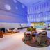 Swiss-Belhotel Mangga Besar in Jakarta lobby with lounge seating and blue-lit high ceiling