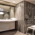 ibis Paris Alésia Montparnasse 14ème bathroom with walk-in shower, mirror and sink in Paris