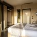 Hotel Premiere in Giugliano in Campania guest room with bed, wardrobe and balcony door