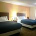 Passport Inn and Suites - Middletown guest room with two beds and bedside lamp