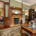 Beaufort House Inn in Asheville living room with fireplace, leather sofa, and coffee table