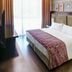 Lennox Hotel Buenos Aires guest room with bed, patterned headboard and city-view window in Buenos Aires