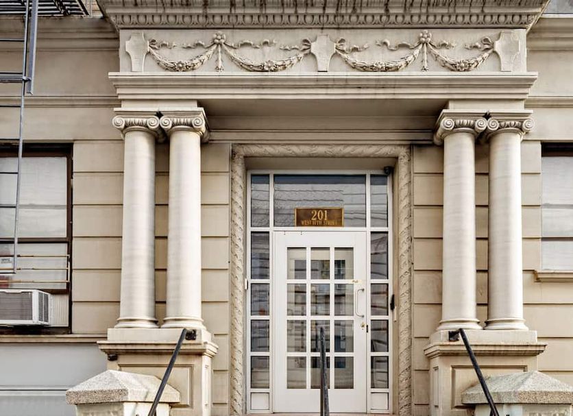 Central Park West Hostel in New York, ornate stone entrance with columns and double doors