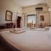 Hotel King Pyrros in Ioánnina guest room with twin beds, balcony door, and city view