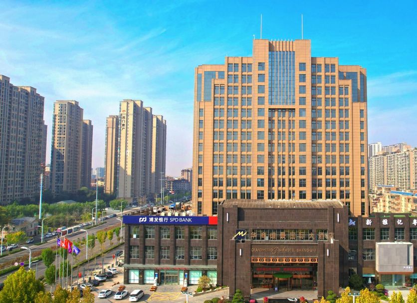 Grand Metropark Hotel Shangqiu exterior with high-rise tower and city skyline in Shangqiu