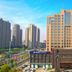 Grand Metropark Hotel Shangqiu exterior with high-rise tower and city skyline in Shangqiu