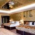 The Shankly Hotel Liverpool room with three beds, mirrored ceiling, and ornate gold decor