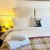 Little Silver Country Hotel in Tenterden bedroom with neatly made bed, bedside lamps and folded towels