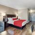 SureStay by Best Western Greenville guest room with king bed, sofa, and work desk