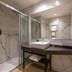 iH Hotels Milano Watt 13 bathroom with glass shower, marble walls, and vessel sink in Milan