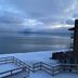 Crown Motel in Kings Beach with snowy lakefront view and railing over calm water