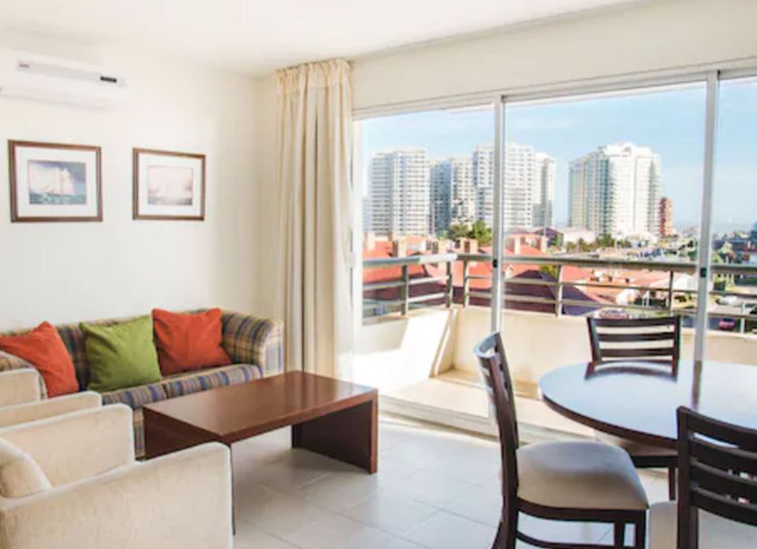 Hotel Sunset Beach in Punta del Este living room with balcony and city skyline view