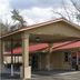 Executive Inn in Rocky Top with a covered driveway and beige entrance under a red roof