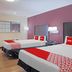 OYO Hotel Mcallen Airport South in McAllen room with two beds and red accent bedding