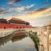 Beijing Hwa Apartment Hotel in Beijing with a view of historic palace walls and moat at sunset