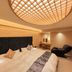 Honjin Hiranoya Kachoan in Takayama: stylish bedroom with a large bed and illuminated circular ceiling light