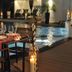 Hotel Rossini in Lignano Sabbiadoro: candlelit dining setup beside a lit outdoor pool at night
