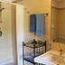 Flegrea House - Casa Rosa bathroom in Pozzuoli with shower, sink, towels and mirror