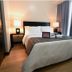 Home Edge Accommodations @ Tivoli Garden Residences Manila bedroom with queen bed and bedside lamps