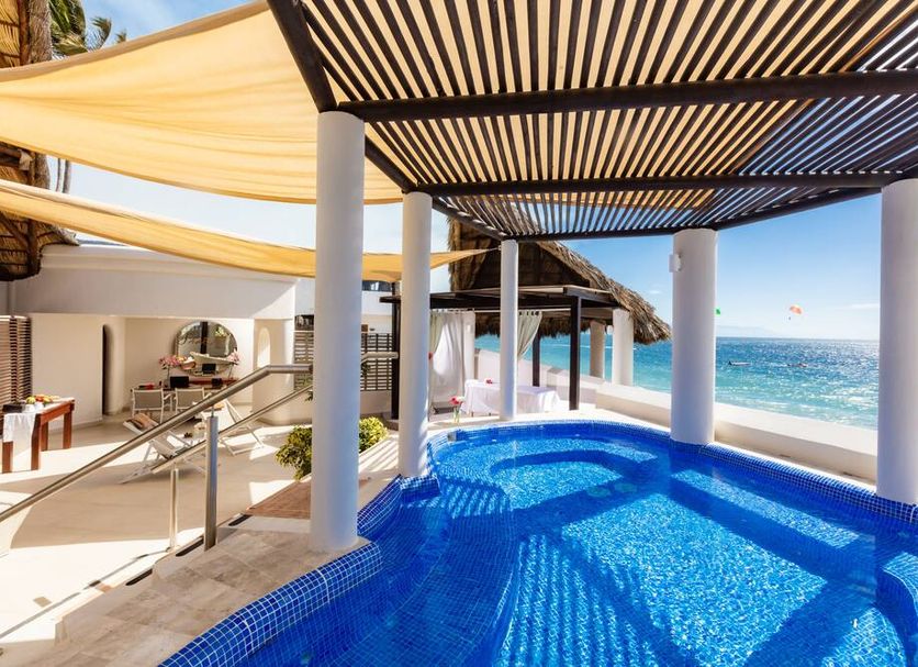 Buenaventura Grand Hotel & Great Moments in Puerto Vallarta with a shaded oceanfront pool and sea view