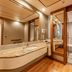 Pestana São Paulo bathroom with double vanity, large mirror and glass-enclosed shower