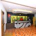 Hotel NavaRATNA Coimbatore lobby with reception desk, black sofa, and patterned tile floor