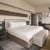 Shangri-la Surabaya guest room with king bed, desk, chair, and modern neutral decor in Surabaya