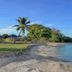 Nila Beach Resort in Lautoka with a palm-lined sandy beach and calm blue water