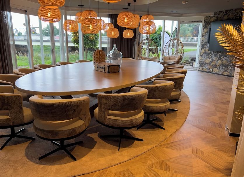 De Zon Hotel & Restaurant by Flow in Ommen meeting room with oval table and orange pendant lights