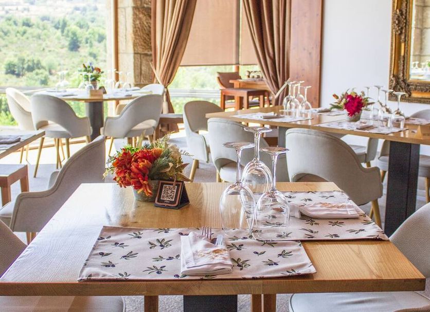 Hotel Rural Casa de Samaioes in Chaves dining room with set tables and countryside view