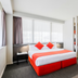Abode Woden Canberra bedroom with orange bed and modern open-plan layout