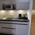 Weserlounge Hotel Garni kitchenette in Hessisch Oldendorf with sink, microwave and coffee maker
