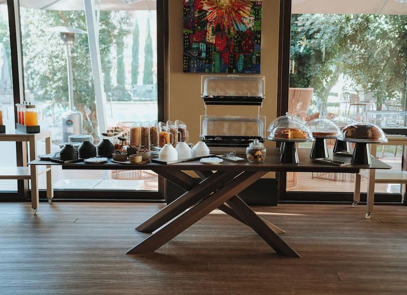 Breakfast buffet at Antum Hotel in Benevento with pastries, coffee, and covered serving dishes