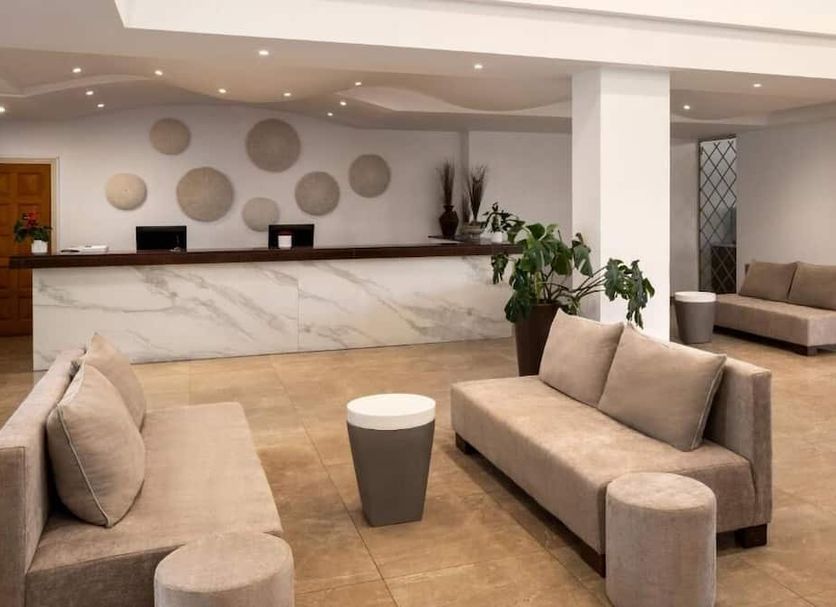 The Freij Resort by Marissol lobby in Ayia Napa with marble front desk and beige seating