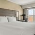 Residence Inn by Marriott Davenport guest room with king bed, desk, and window view