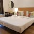 The Unicontinental - Campus Accommodation in Mumbai, guest room with double bed, desk, mirror, and bedside lamps.