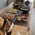 Breakfast buffet at Le Mirage in Bormes-les-Mimosas with bread, pastries, fruit and bowls on a wooden table