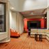 Courtyard by Marriott Dallas-Fort Worth/Bedford lobby with fireplace, seating area, and TV in Bedford