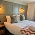 The Punch Bowl, Woodstock hotel room with double bed, bedside table and wall sconces