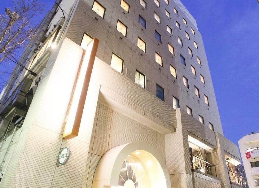 Alley Hotel Hiroshima Namikidori exterior in Hiroshima with a lit arched entrance at dusk