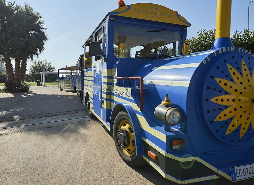 Riva Marina Resort - Cdshotels in Carovigno with a blue tourist train shuttle outside