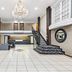 Baymont by Wyndham Port Arthur/Groves Area lobby with chandelier, staircase and seating area in Port Arthur