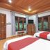 OYO 75353 Loy Chalet Resort room in Nakhon Si Thammarat with twin beds and large windows