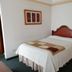 Hotel Bolivar Plaza in Manizales guest room with a single bed and nightstand