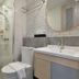 BS Residence Suvarnabhumi in Bangkok bathroom with shower, toilet, sink and round mirror