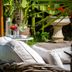 Hôtel Du Centenaire in Les Eyzies-de-Tayac-Sireuil, wicker lounge chairs with drinks in a garden setting