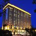 Shenyang Neu International Hotel in Shenyang, lit high-rise hotel exterior at night