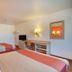 Motel 6 Twentynine Palms room with two beds, desk, TV and wall mirror in Twentynine Palms